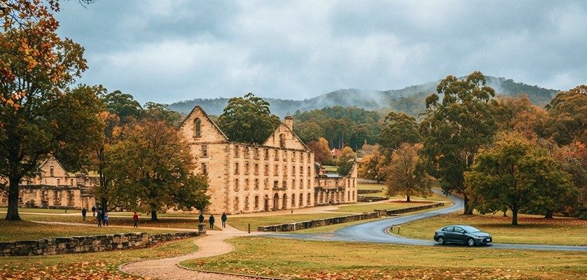 Historic ruins at Port Arthur in Tasmania surrounded by trees and autumn scenery