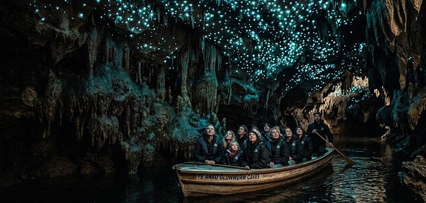 Te Anau Glowworm Caves showcasing a boat tour across the lake to underground limestone caves illuminated by bioluminescent glowworms